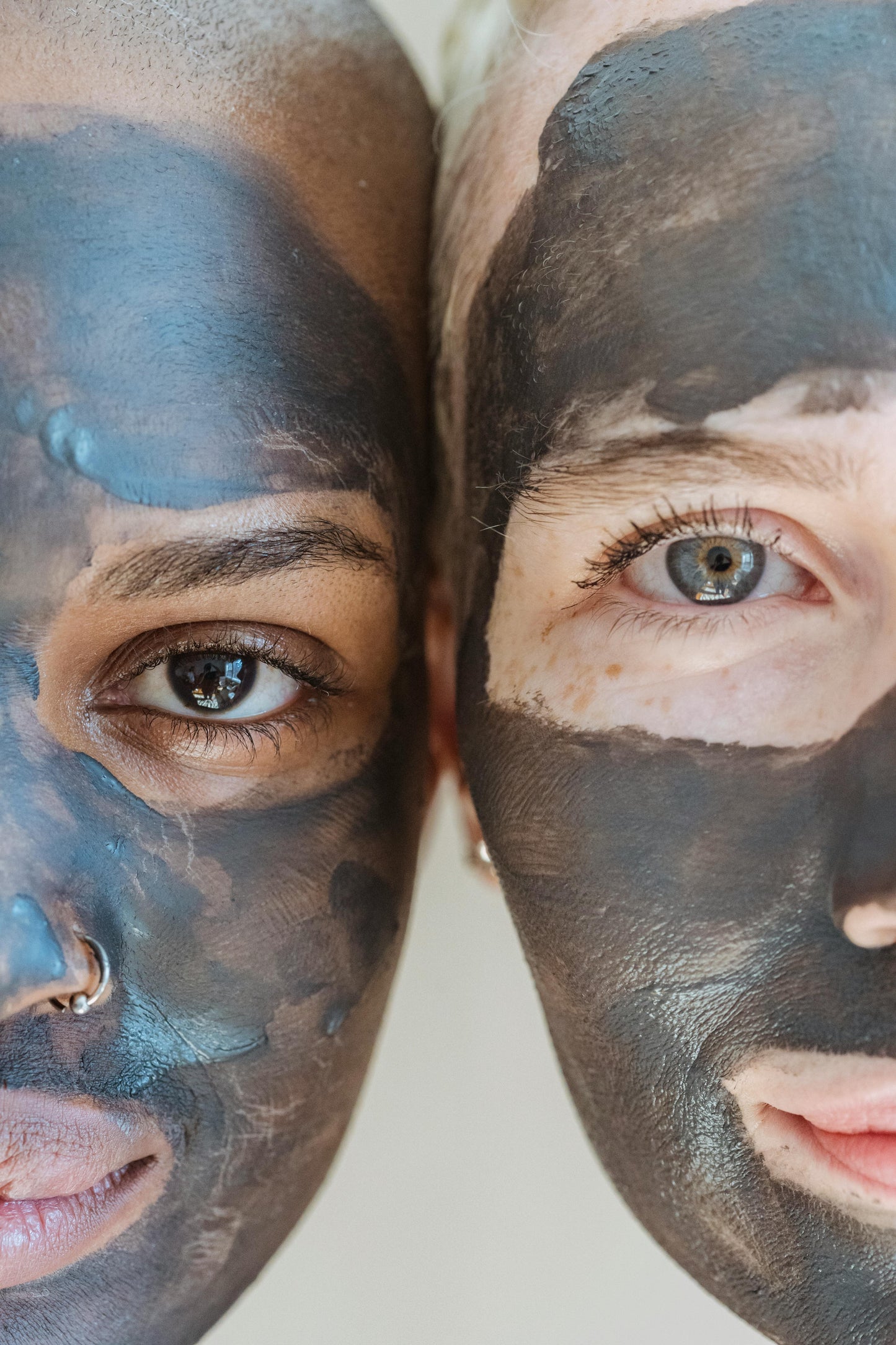 Two people with black face masks on a white background