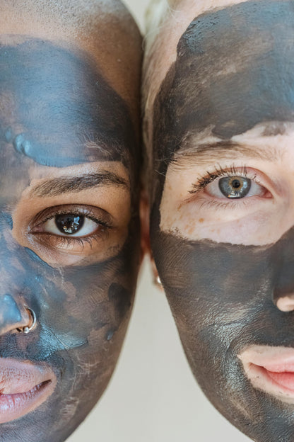 Two people with black face masks on a white background